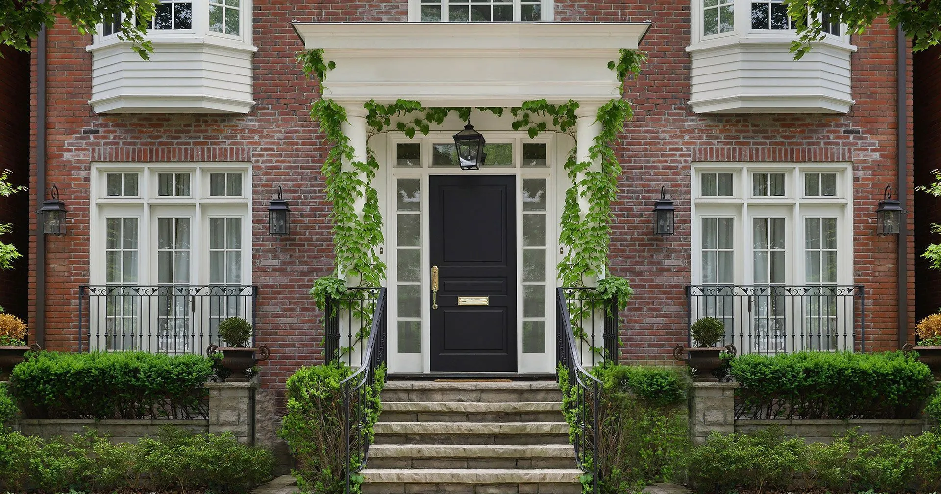 Black entry door on classic brick home